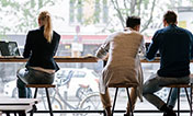 people in cafe bar using mobile devices